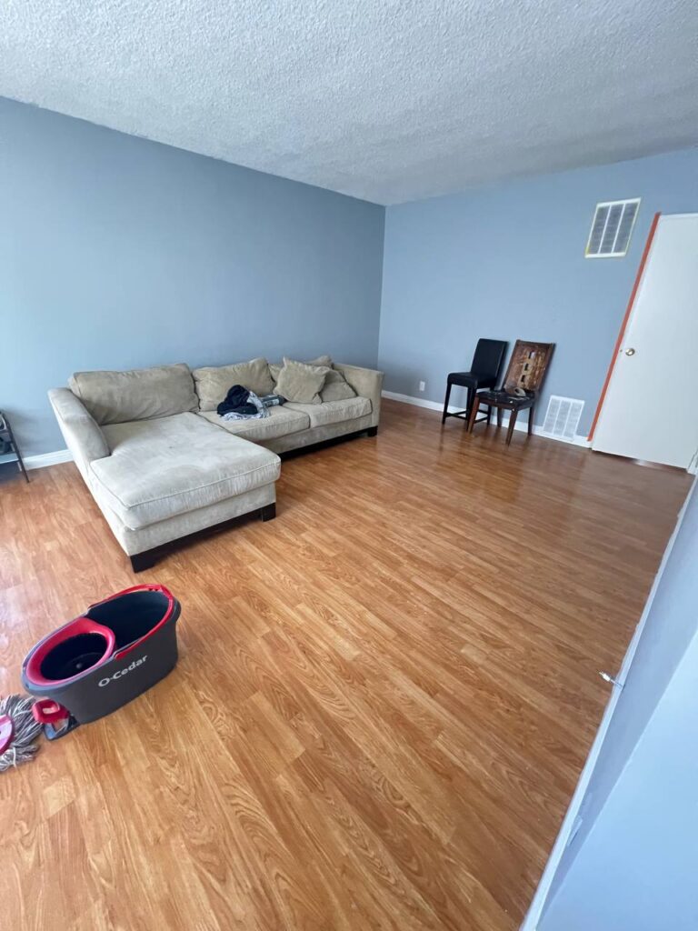 Move-out cleaning in progress – empty living room being vacuumed in Los Angeles