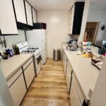 Deep cleaned kitchen with organized countertops and polished hardwood floor in Los Angeles apartment