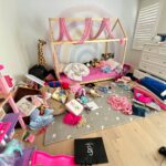 Messy kids room with toys scattered on the floor before professional organization and cleaning.