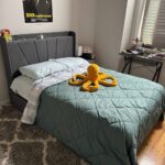 Organized bedroom after professional decluttering — neatly made bed, clean surfaces, and peaceful atmosphere.