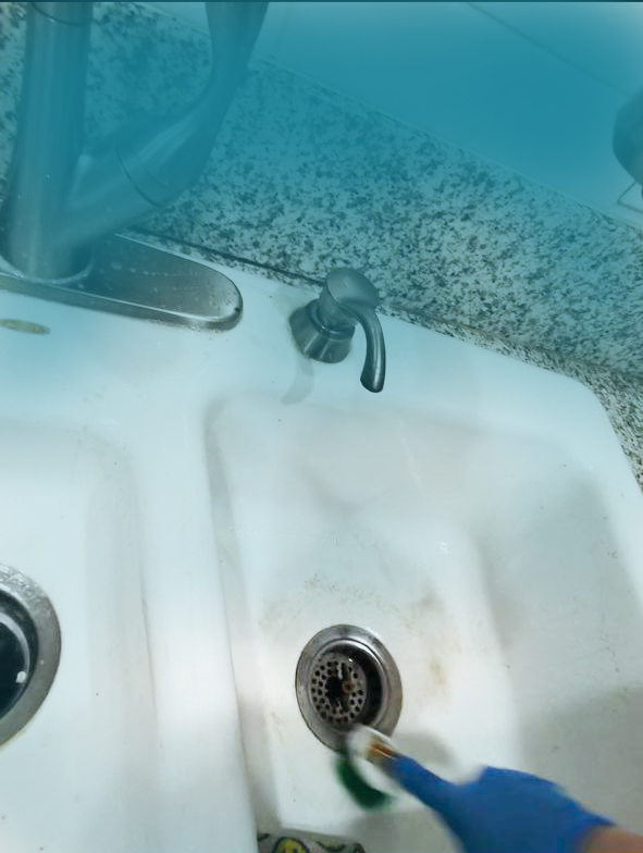 Aquamarine Pro Team deep cleaning a bathroom sink in Los Angeles